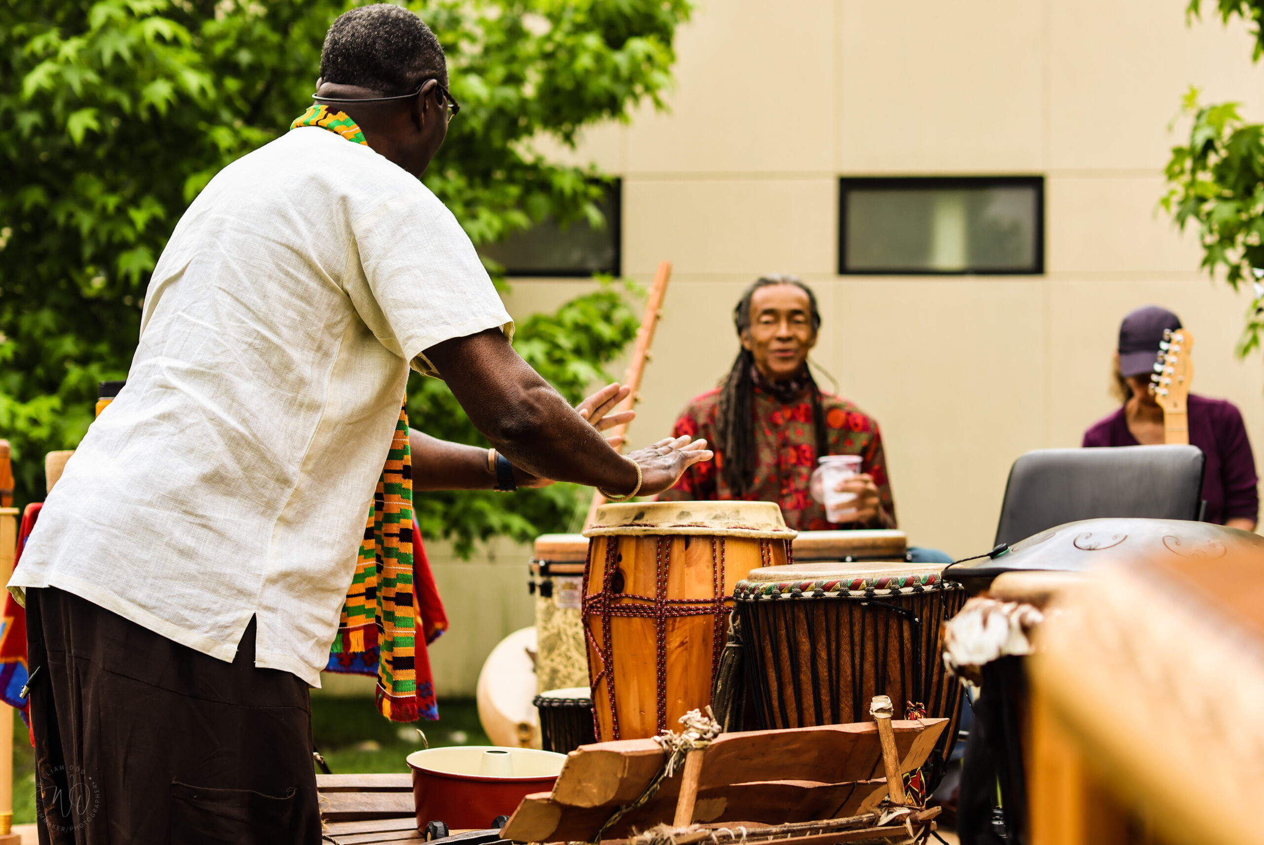 Playing of traditional West African percussion instruments in a group.